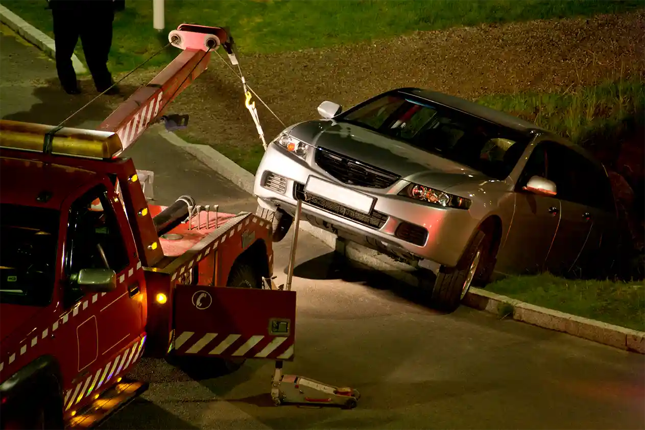 Car being winched out of sinkhole