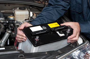 Mehcanic Replacing Battery of Car
