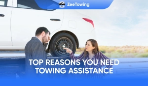 Driver receiving roadside towing assistance beside disabled vehicle on highway