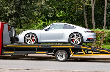 Silver luxury car getting towed